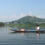 A man is doing boating in Srinagar Travel Tips: Plan your trip to Srinagar on New Year 2024!