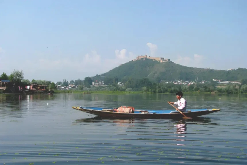 A man is doing boating in Srinagar Travel Tips: Plan your trip to Srinagar on New Year 2024!